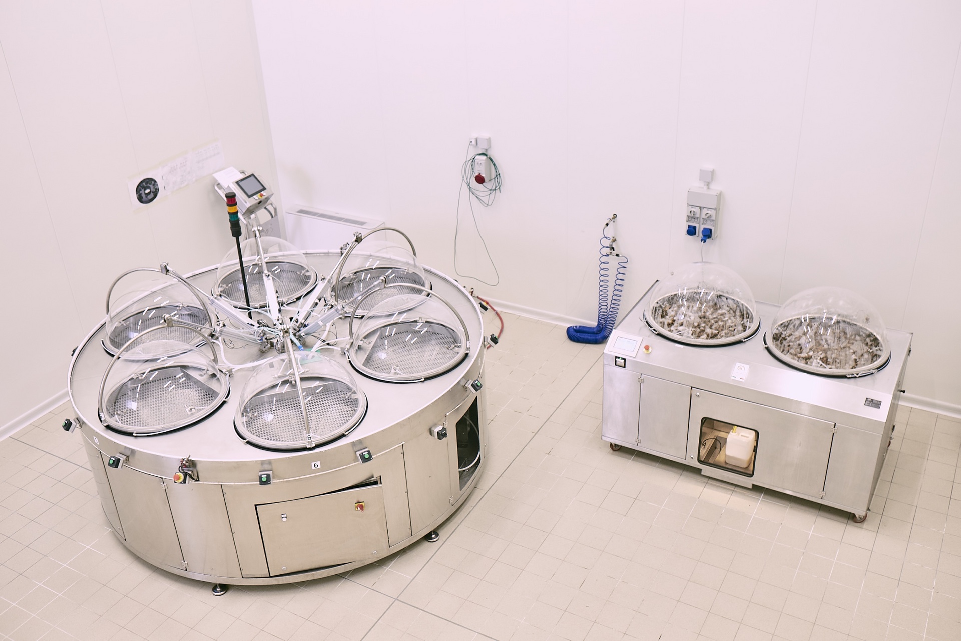 Two Muller slime extractors side by side in a white room.